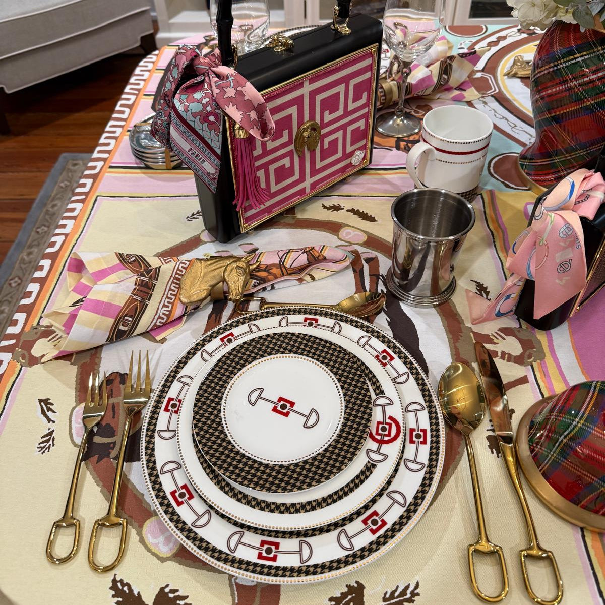 Decorative table setting with a patterned tablecloth, plates, and cutlery.